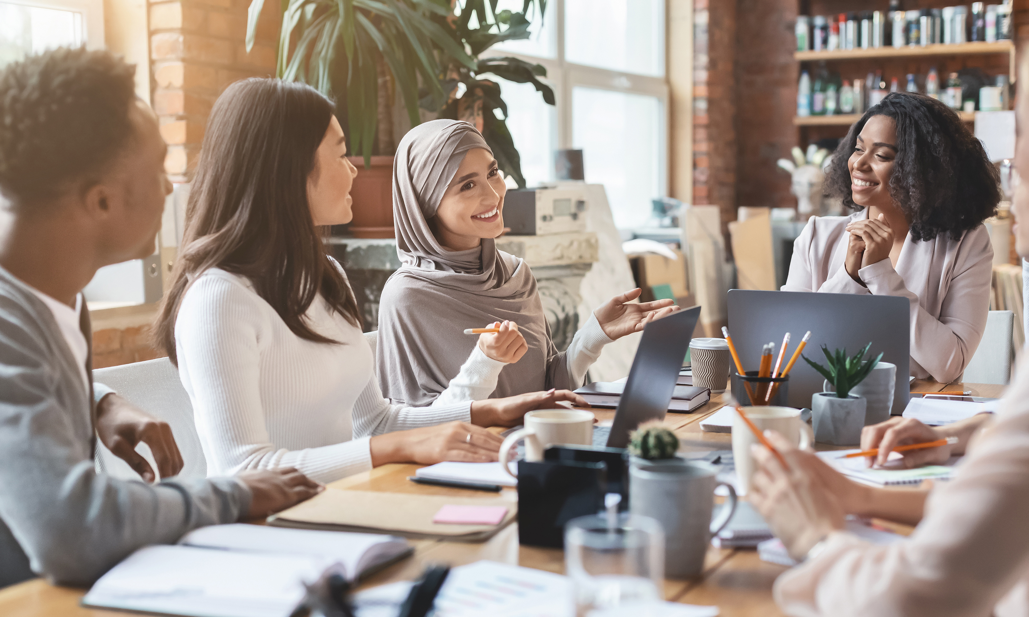 Young multiracial people having business meeting in office