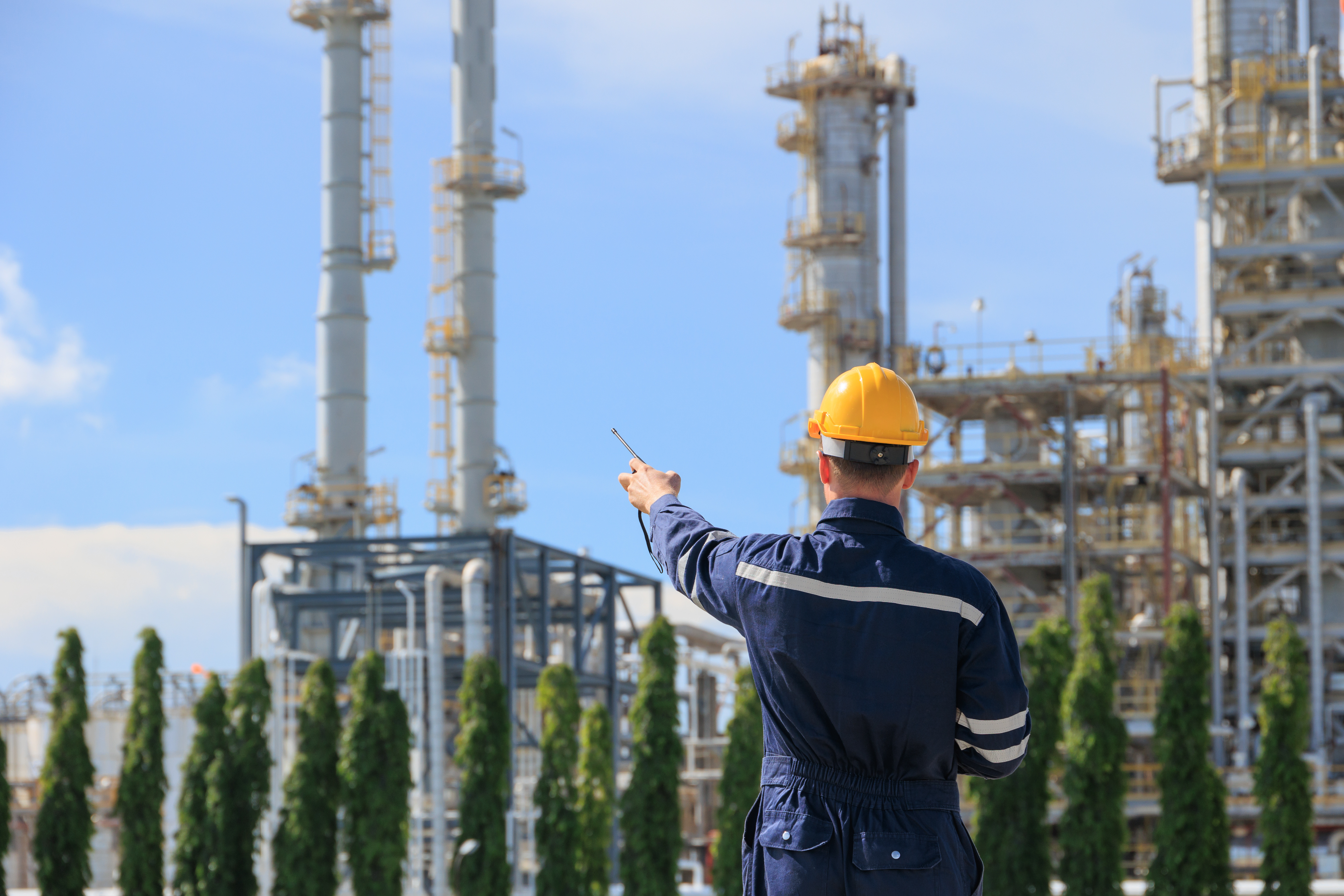 Refinery petroleum worker on duty radio control operation. Industrial Engineer in oil and gas working in petrochemical plant.