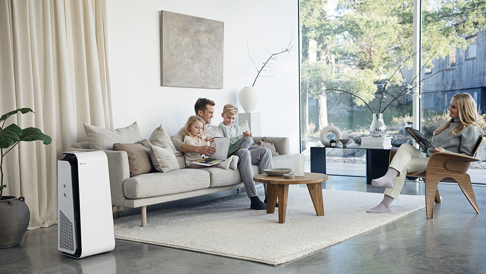 Family sitting in their living room with a Blueair device visible