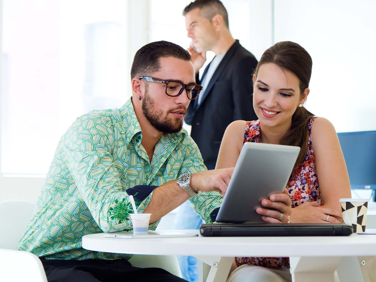 man and woman using tablet 