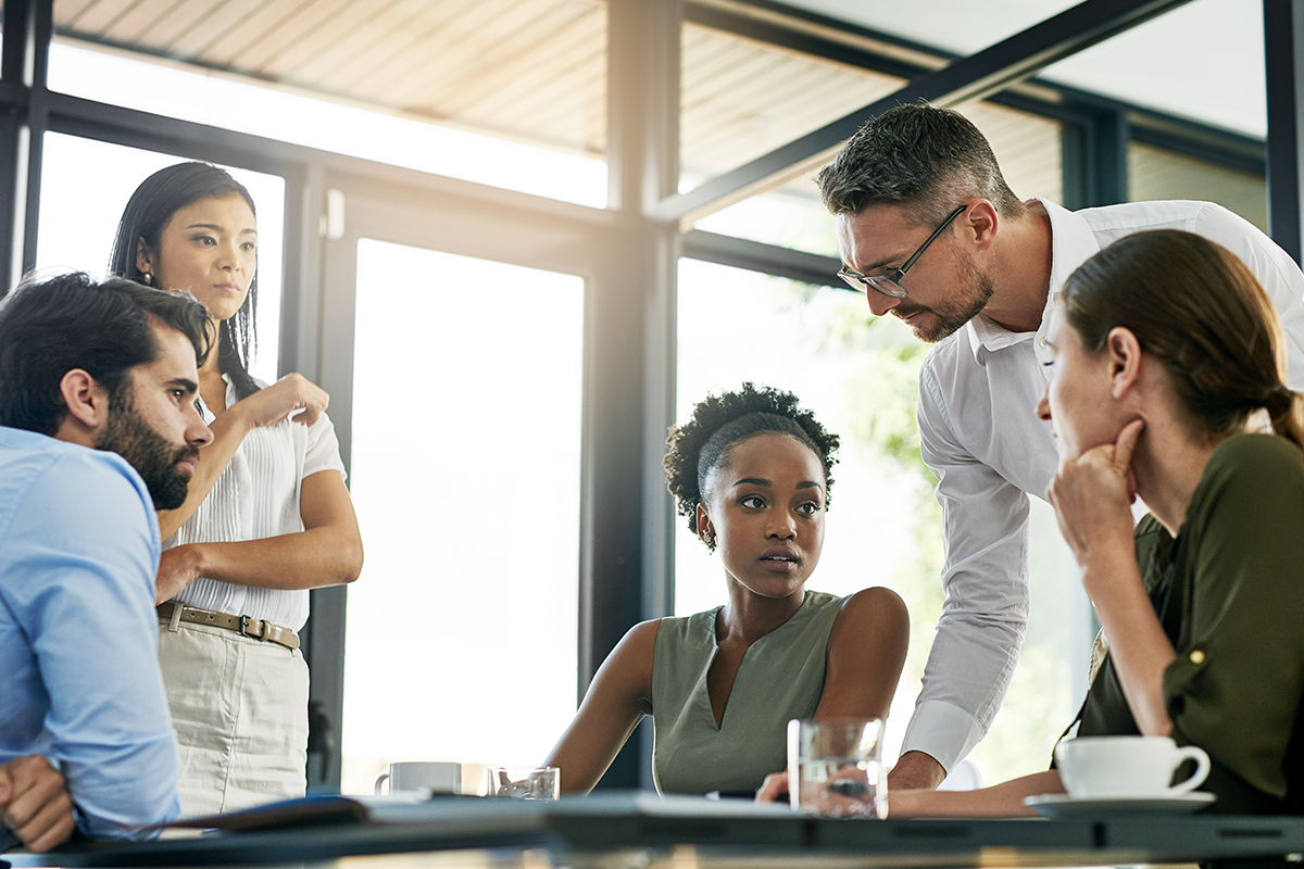 They have some important decisions to make as a team. Shot of a group of colleagues working together in an office.