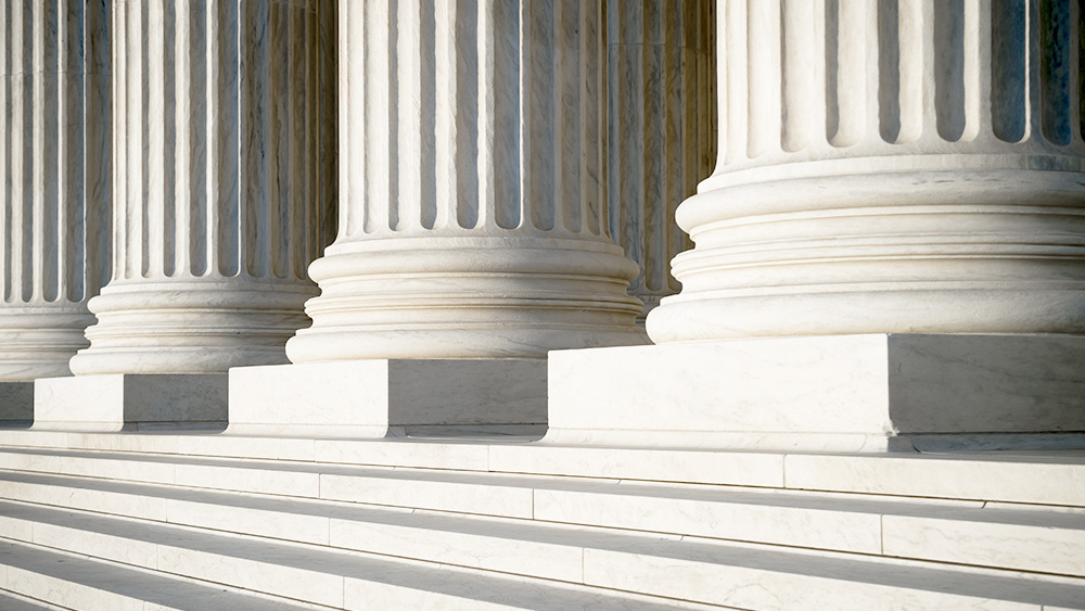 Abstract view of neoclassical fluted columns, bases and steps of the US Supreme Court building in Washington DC