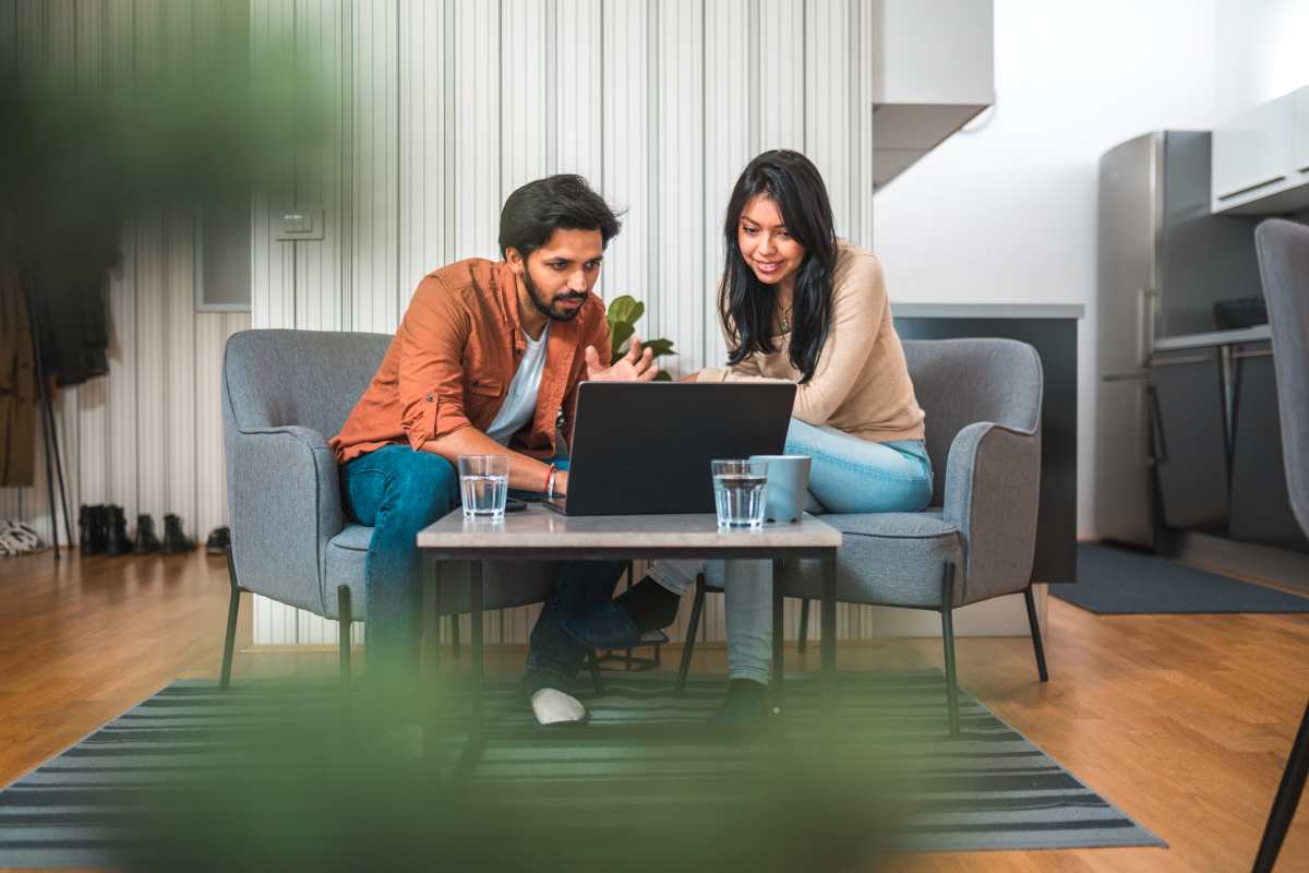 stock image of two people working on a laptop