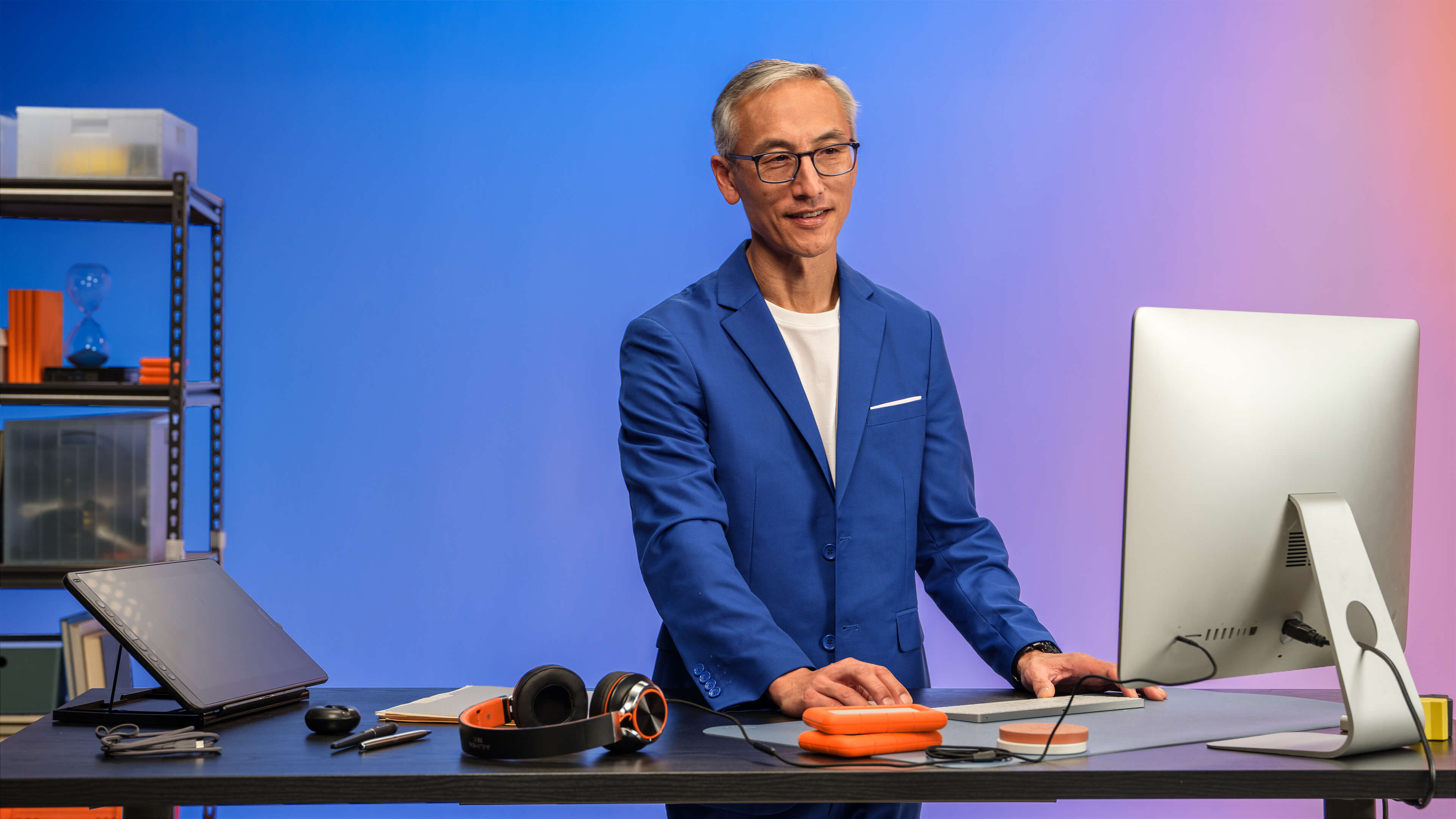 asian man working on standing desk