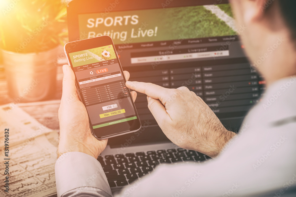 person placing sports bets on mobile device