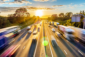 heavy traffic moving at speed on UK motorway in England at sunset