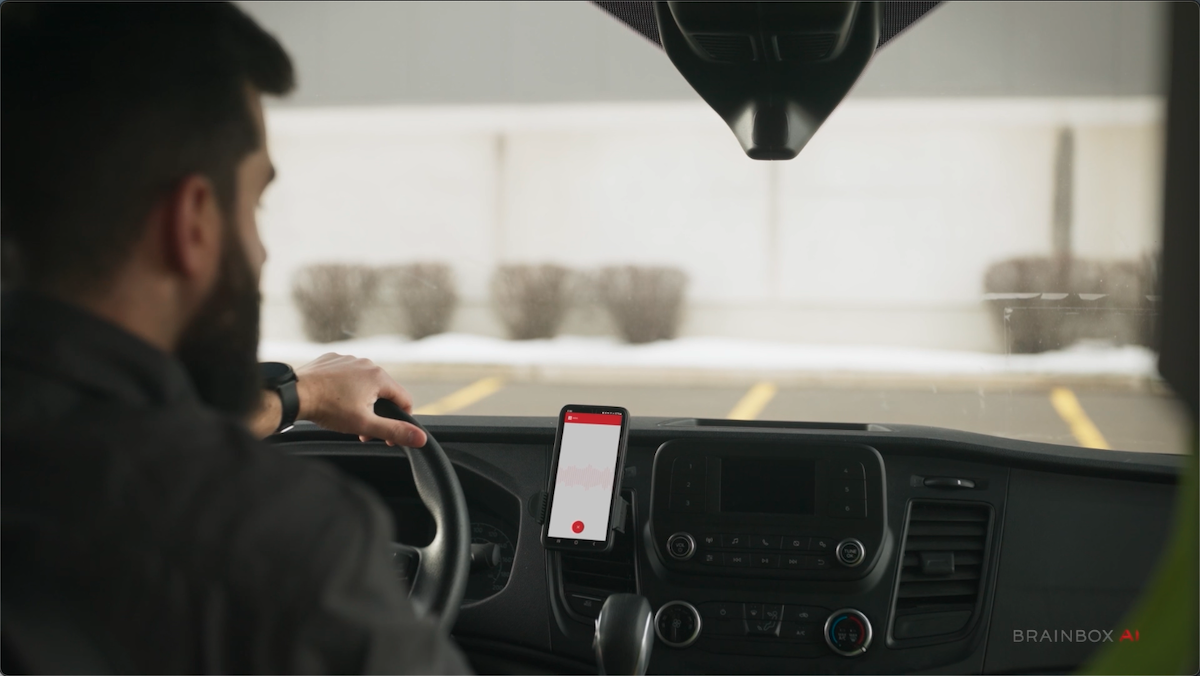 person in car with ARIA technology on the smartphone