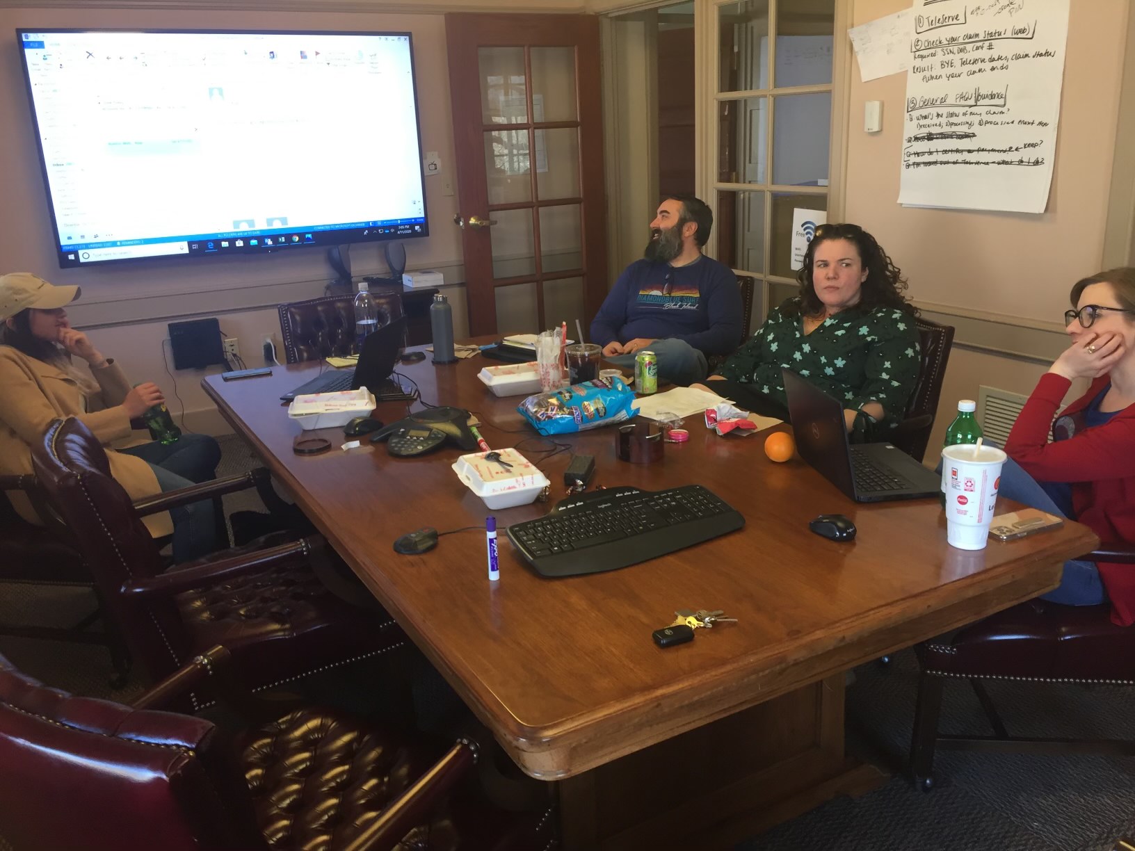 Members of the Rhode Island DLT team gather at a table for an AWS Digital Innovation session. 