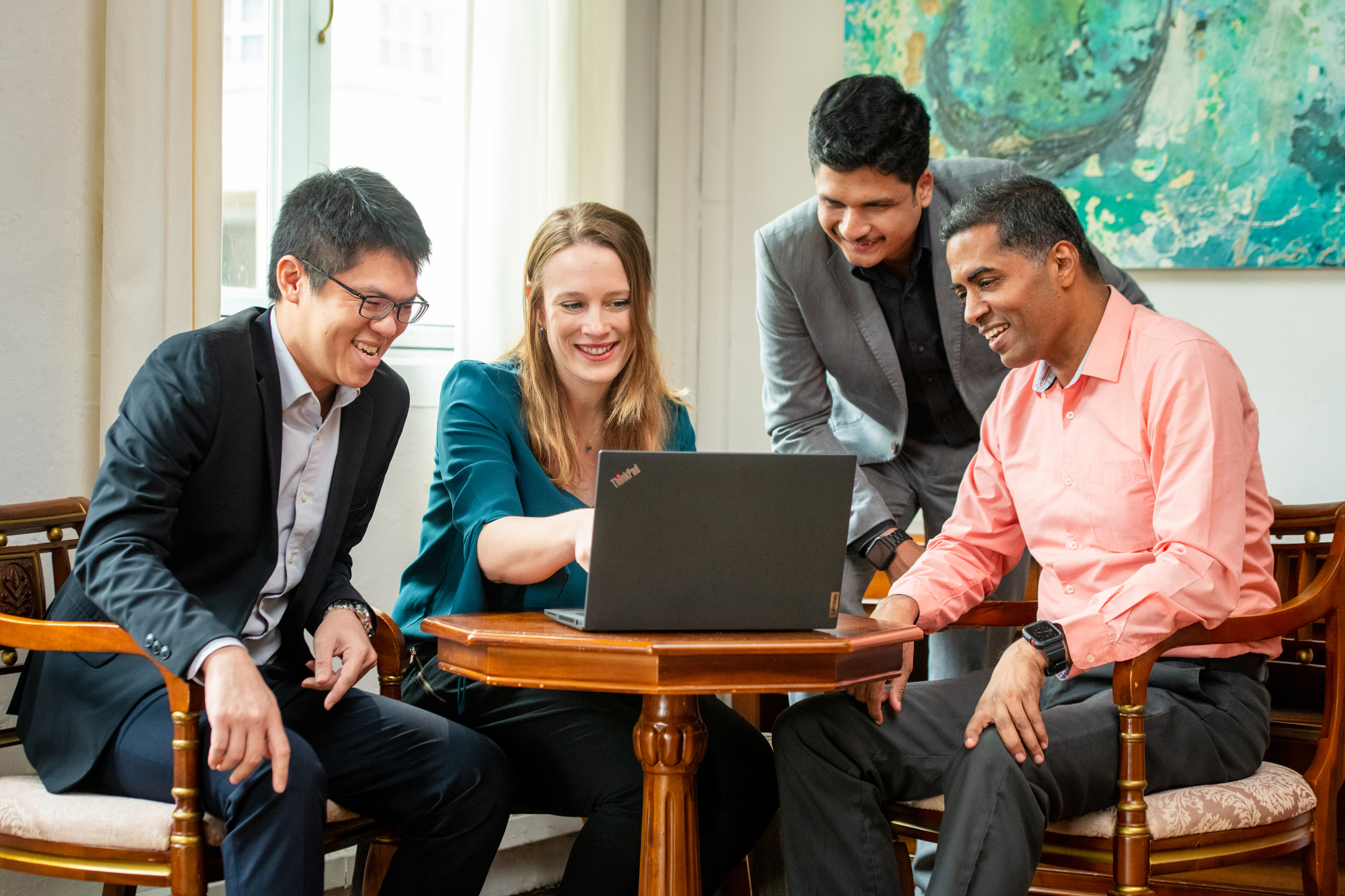 People sitting around computer