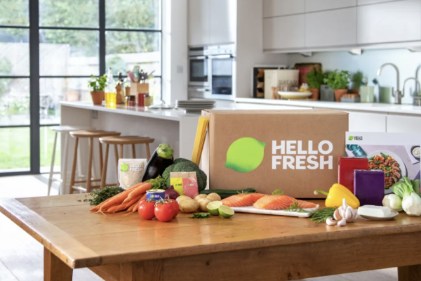 Hello Fresh box on a kitchen table with food