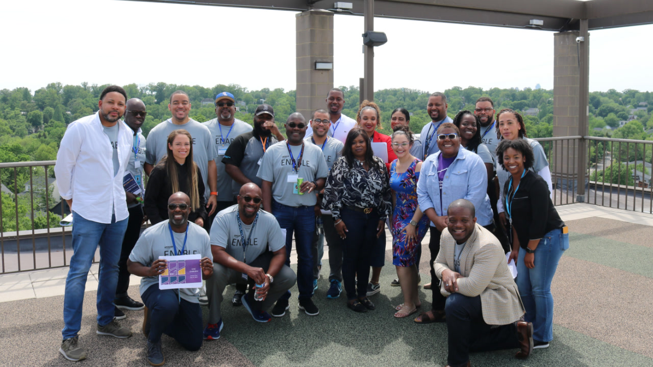 Amazon employees got together for the third annual ENABLE Summit,  which stands for Empowering Network of Amazon Black Executives. About 15 men and women posed together outdoors for the photo.