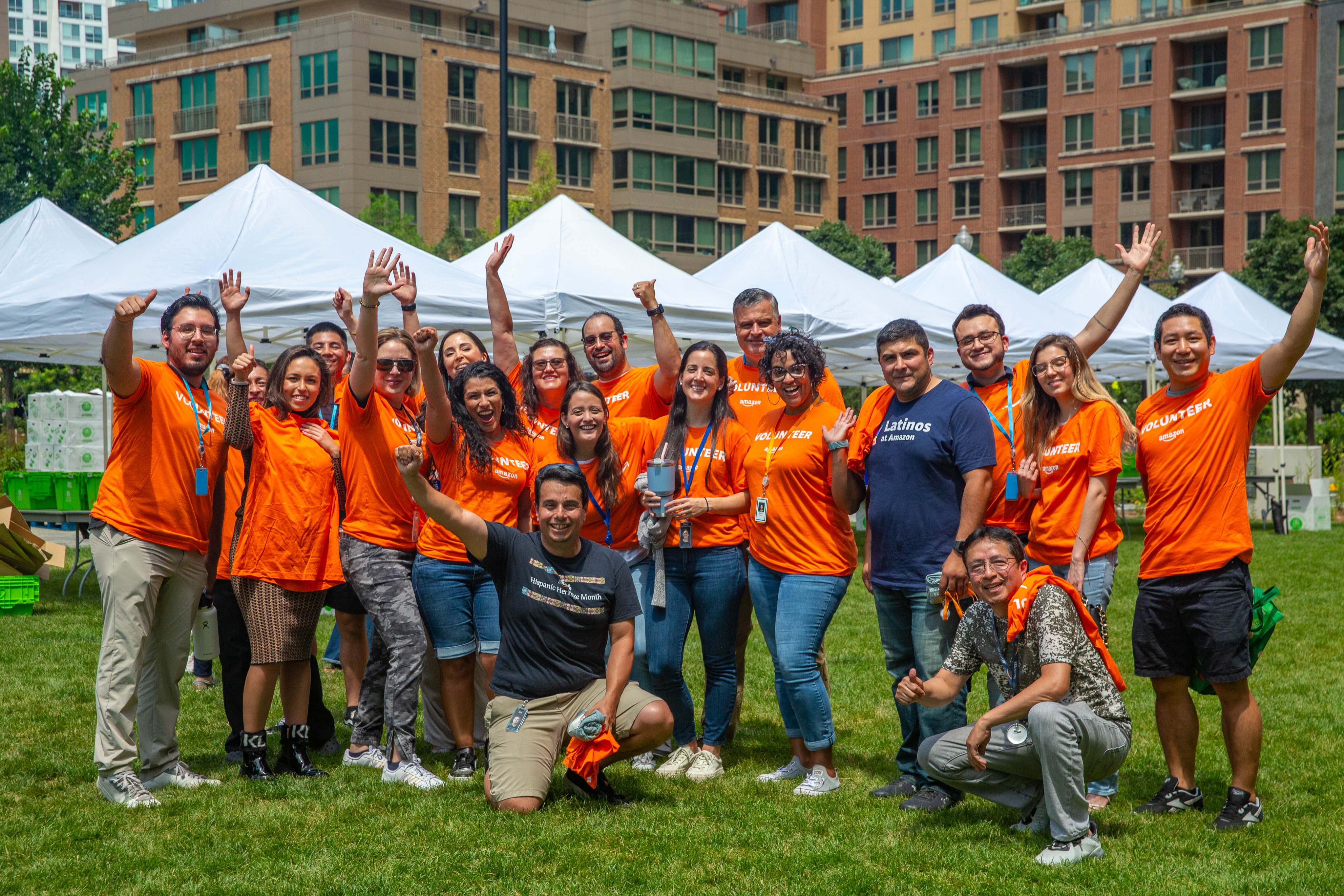 Members of the Latinos at Amazon affinity group pose for a photo, donning their Amazon volunteer T-shirts, after participating in a volunteer event.