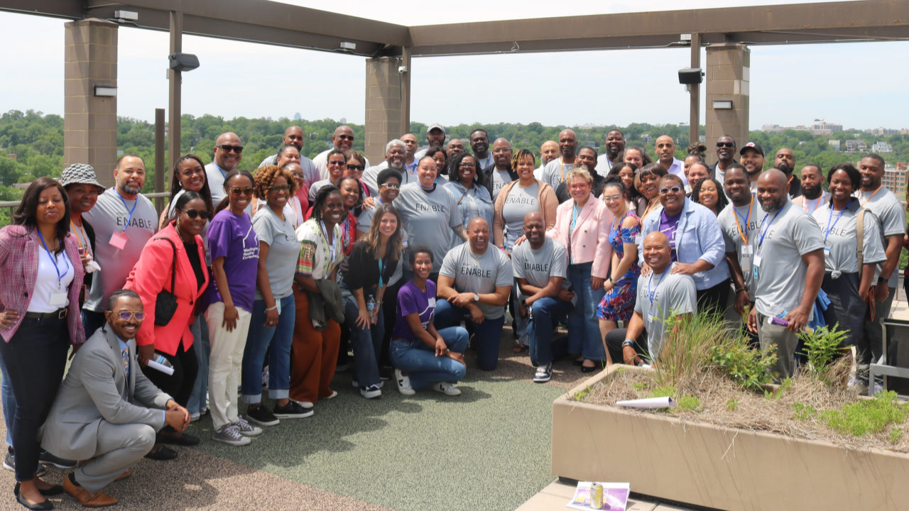 Amazon employees got together for the third annual ENABLE Summit,  which stands for Empowering Network of Amazon Black Executives. About 50 men and women posed together outdoors for the photo.