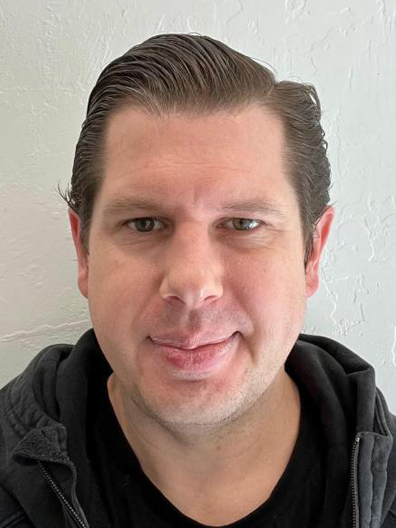 Matthew Krajewski is a senior program manager for accessibility in the AWS Training and Certification organization. The image is a headshot of Matthew, who presents as a white male with short brown hair. 