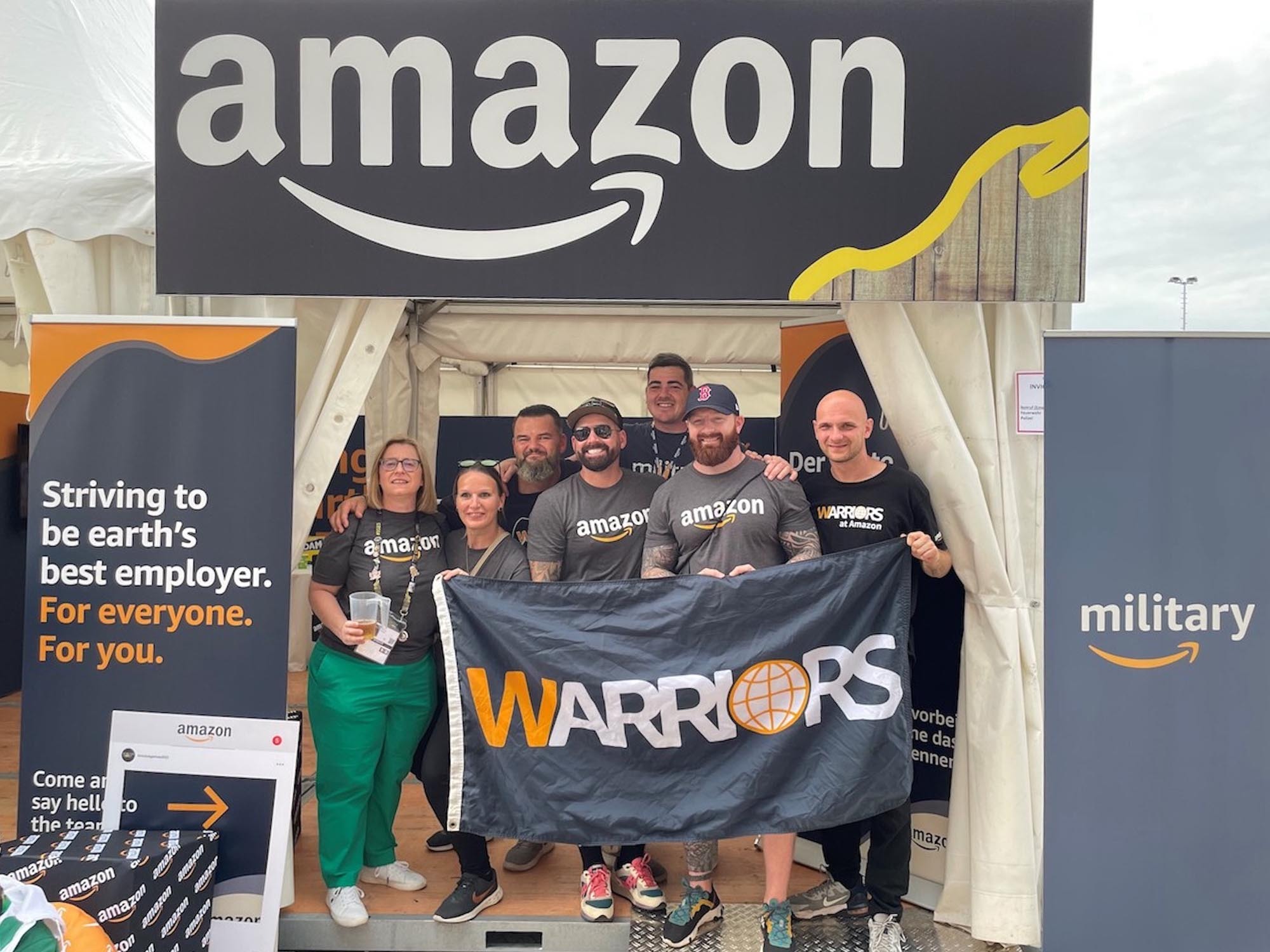 Members of the Latinos at Amazon affinity group pose for a photo, donning their Amazon volunteer T-shirts, after participating in a volunteer event.