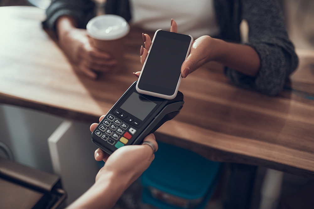 woman-using-phone-for-contactless-payment