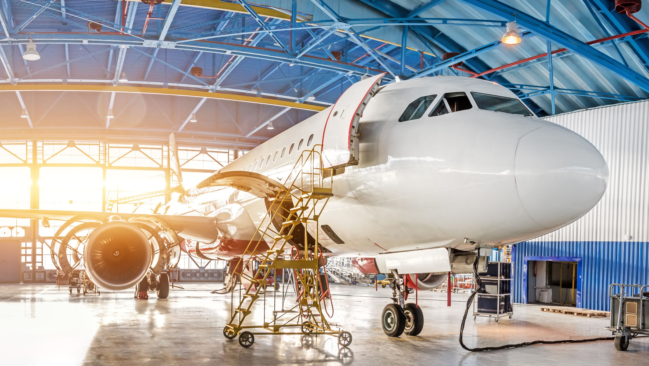 Maintenance and repair of aircraft in the aviation hangar of the airport, view of a wide panorama