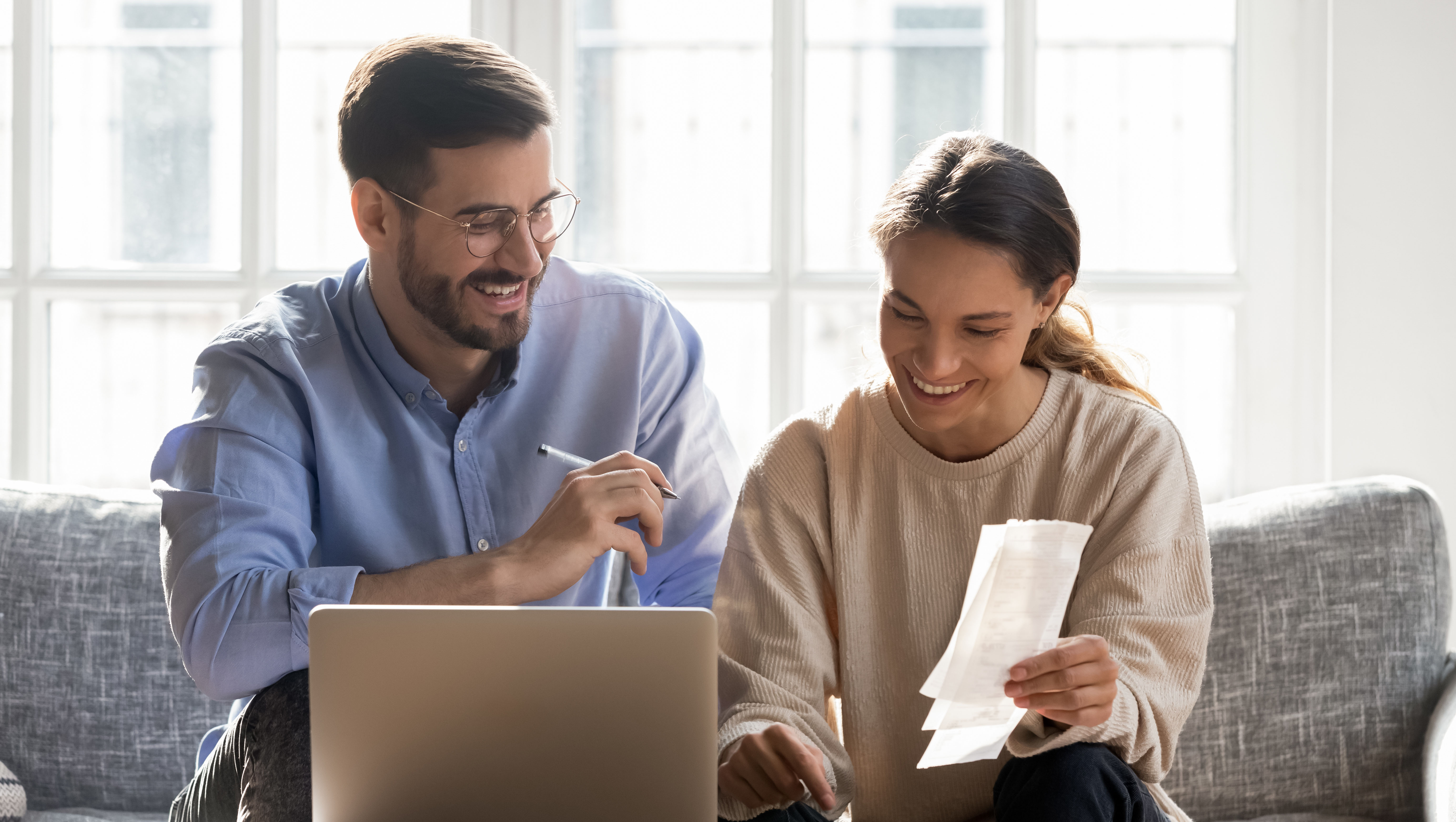 Happy young family couple planning monthly budget.