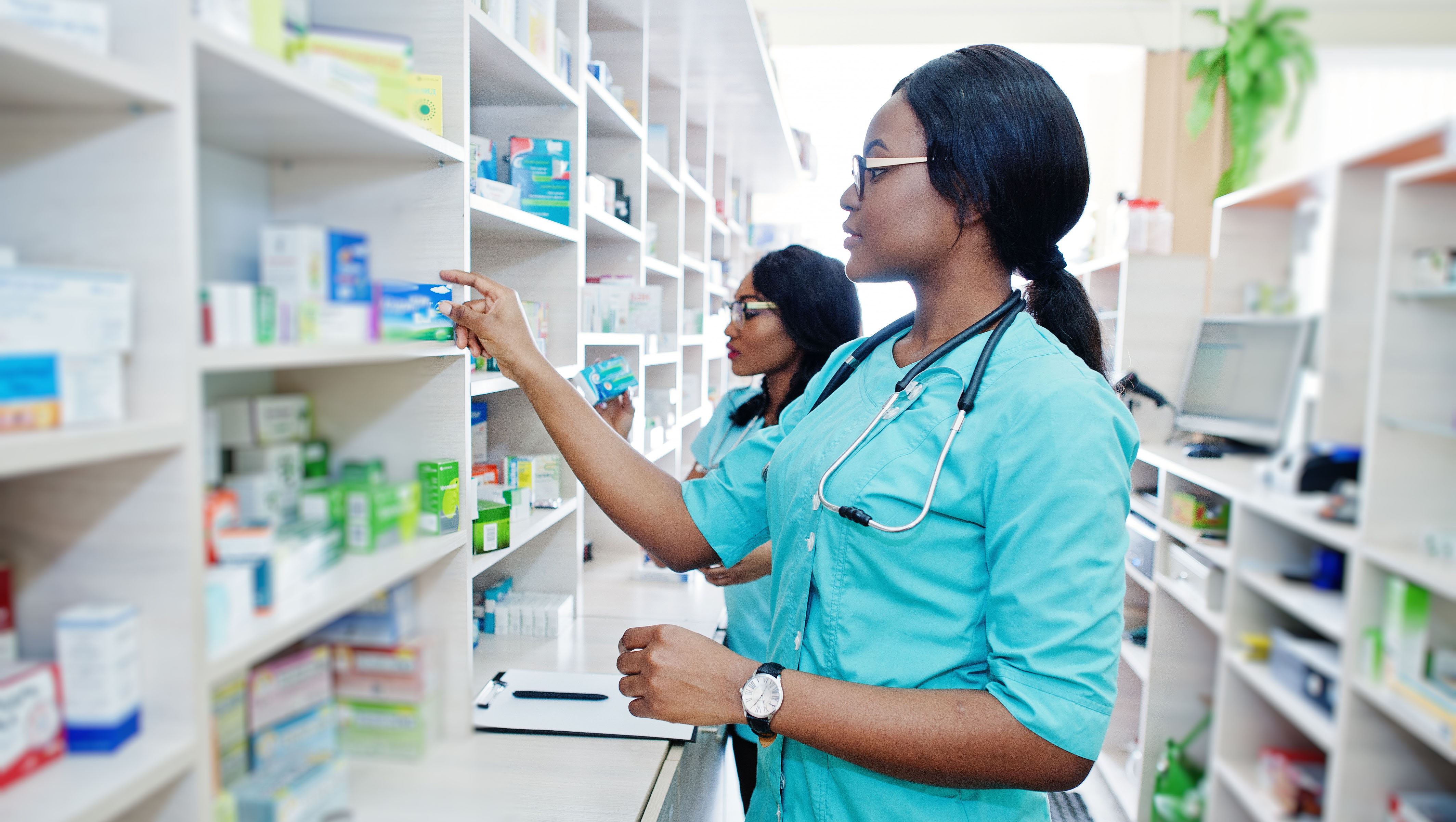 Two african american pharmacist working in drugstore at hospital pharmacy. African healthcare.