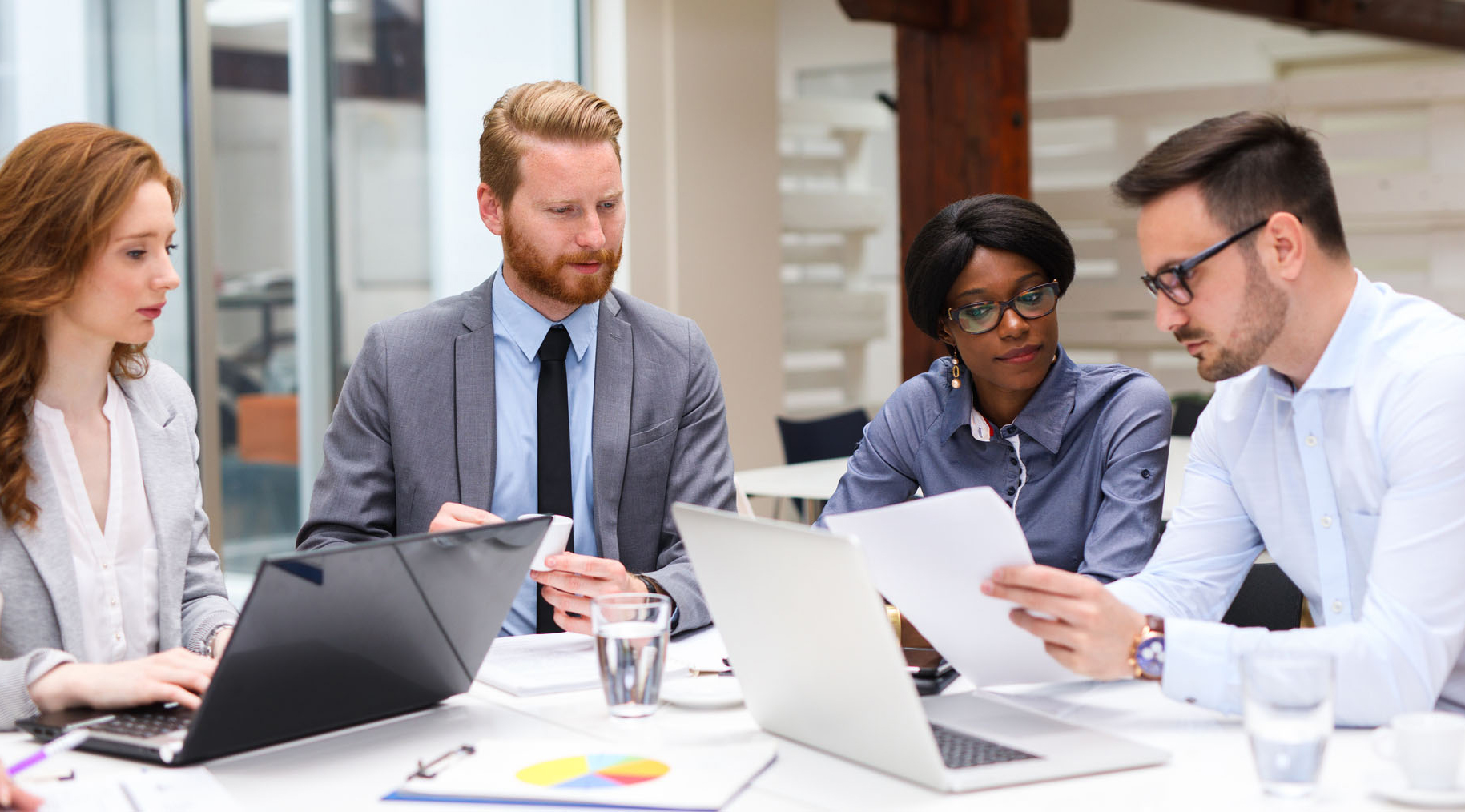 circle of employees working at a table