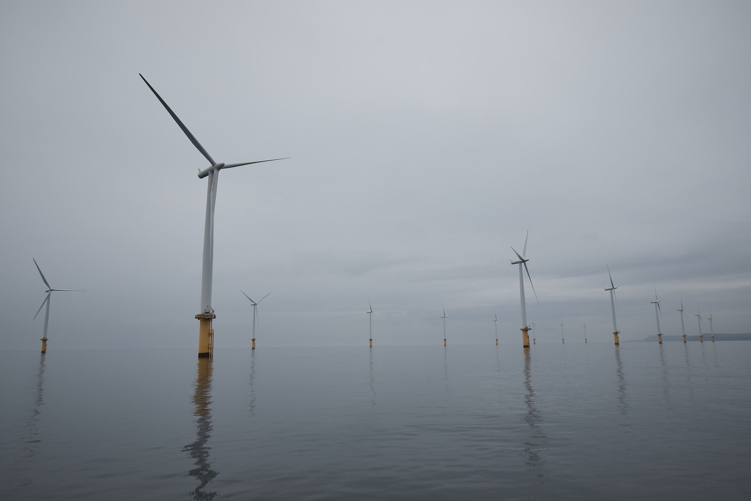 windmills near a large body of water