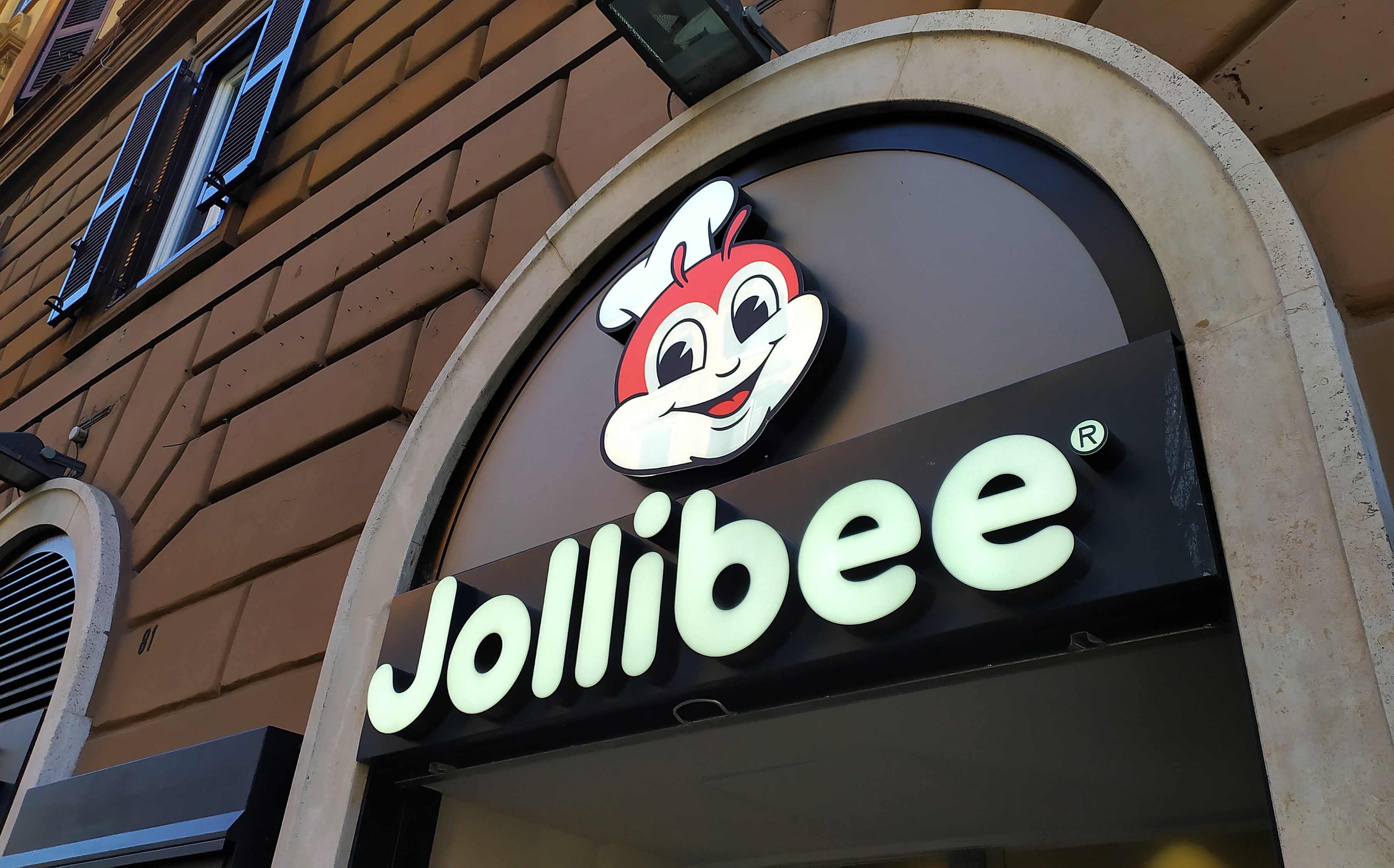 Sign of a Roman branch of the JOLLIBEE fast food chain. Filipino restaurant chain