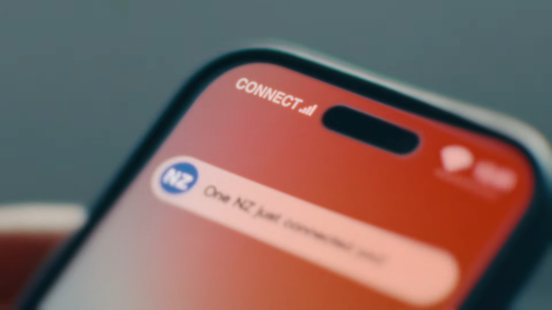 Video about AI-powered telecom customer engagement with Amazon Connect, with a One NZ notification on a smartphone.