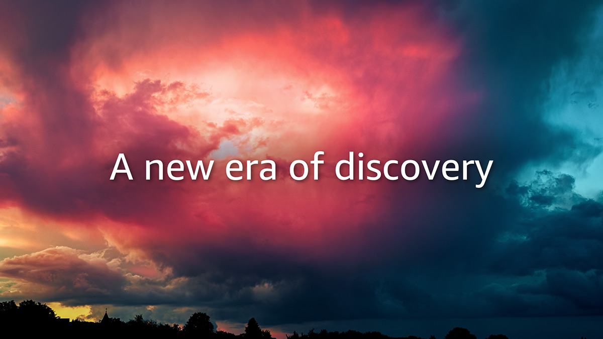 Dramatic red and blue storm clouds at sunset above a silhouetted treeline, overlaid with the words A new era of discovery