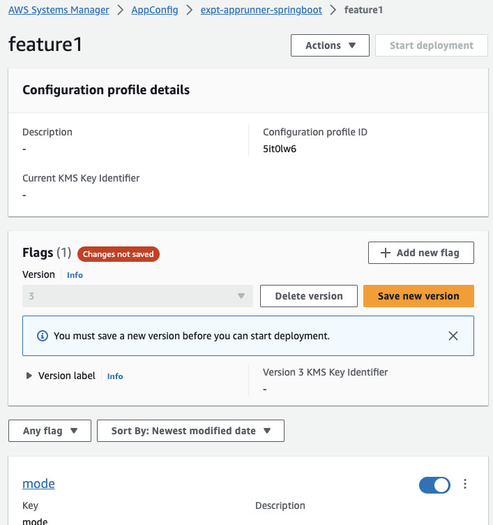 Screenshot of the AWS AppConfig console showing a feature flag configuration profile UI. The image displays configuration profile details, flag management options, and a warning to save a new version before deployment.