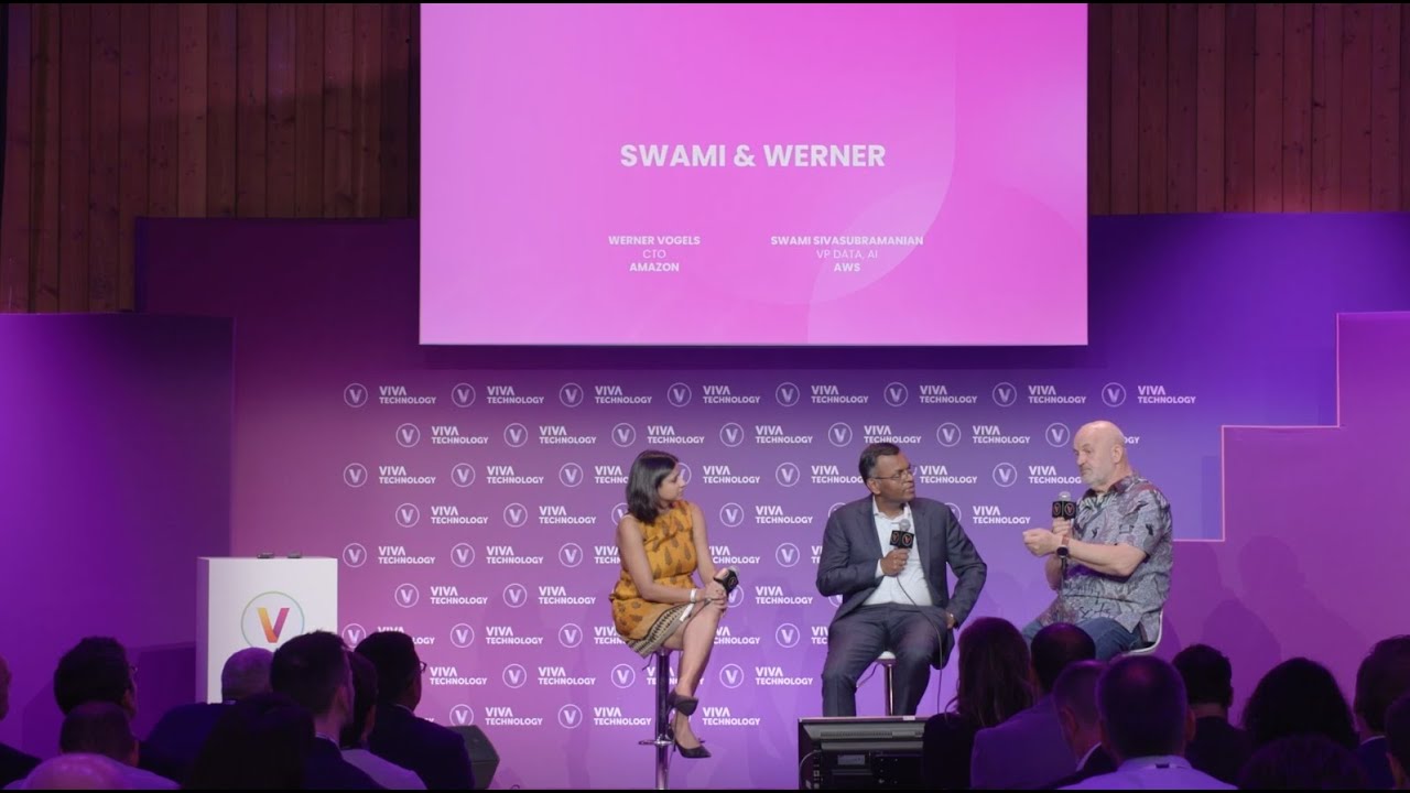 Panel discussion at Viva Technology featuring Swami Sivasubramanian and Werner Vogels on stage, with an audience watching. The backdrop displays 'SWAMI & WERNER' and their titles at Amazon and AWS.