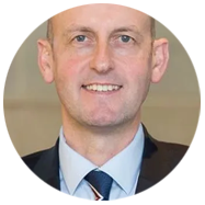 A person wearing a suit, dress shirt, and tie.2