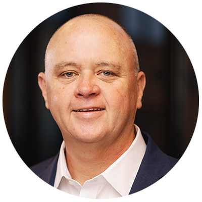 Portrait photo of Scott Reese, CEO of GE Vernova Electrification Software, keynote speaker. The image shows a professional headshot of a bald man in a suit and white shirt, facing forward and smiling.