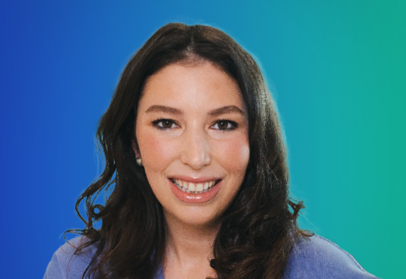 A professional headshot of a woman with long dark hair, smiling, with a blue to green gradient background.