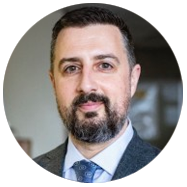 A person wearing a suit and tie in an indoor setting.2