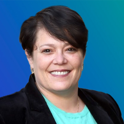 A person wearing a black blazer and a light teal shirt, set against a blue gradient background.