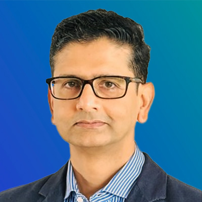 A person wearing a blue blazer and striped shirt against a gradient blue background.