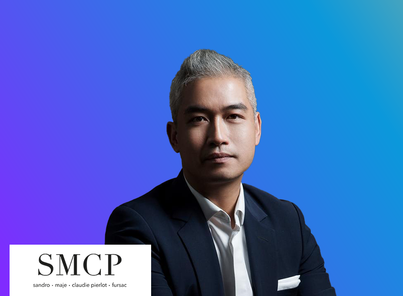 A professional portrait of a man in a suit with a gradient blue background and the SMCP logo in the bottom left corner.