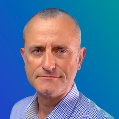 A person wearing a checkered shirt against a blue gradient background.
