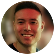 2A person with short dark hair, set against a blurred background.