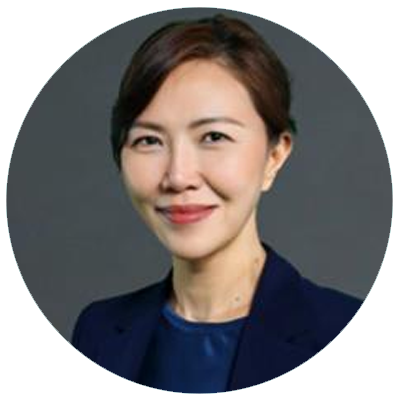 Professional headshot of a woman in a blazer, neutral background