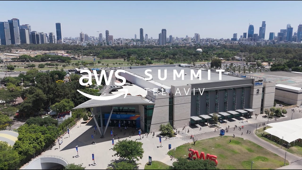 Aerial view of the AWS Summit Tel Aviv venue with the city skyline in the background, featuring the AWS Summit Tel Aviv logo overlay.