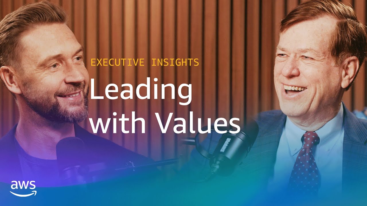 Text overlay reads "Executive Insights: Leading with Values" with microphones visible against a wooden panel background.