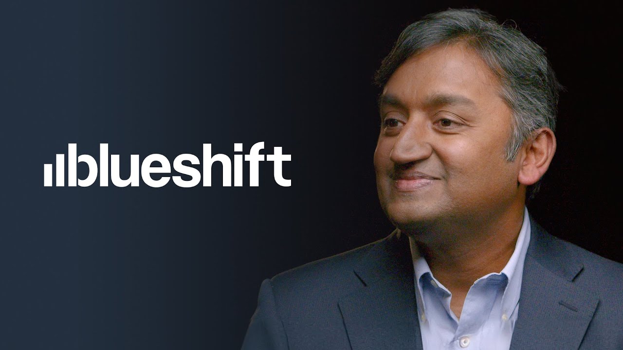 The "blueshift" logo on a dark background next to a person in a suit.