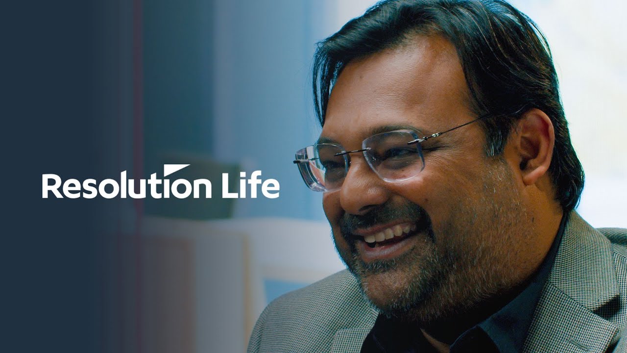 YouTube thumbnail for Resolution Life featuring a smiling man wearing glasses and a suit.