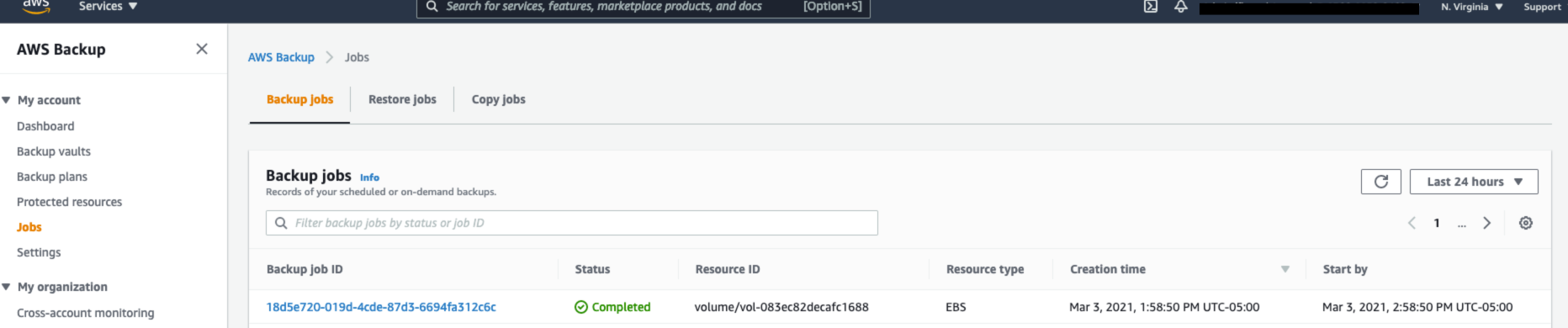 Alt-text: AWS Backup interface showing a completed backup job for an EBS volume with details including job ID, resource type, and timestamps.