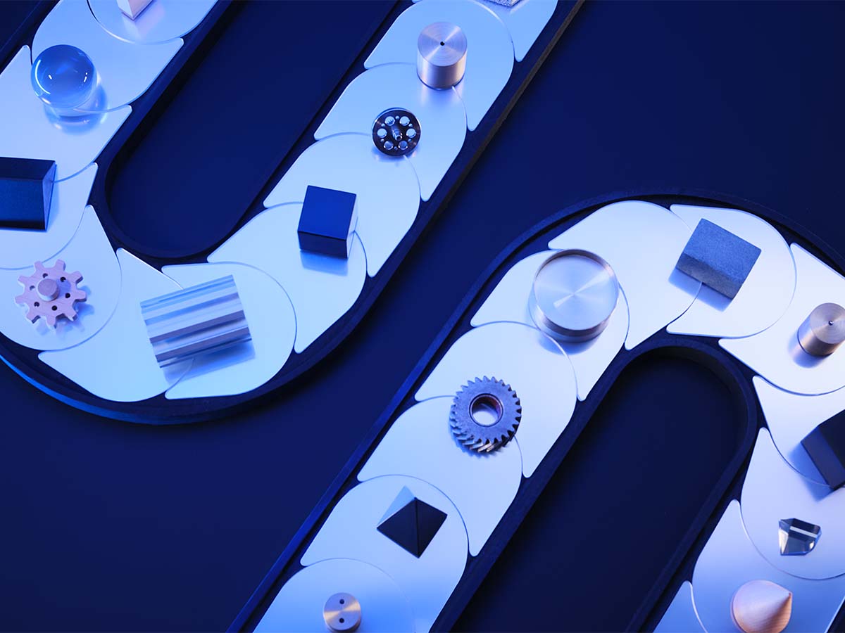 Metallic and geometric objects arranged on a curved conveyor-like surface under blue lighting.