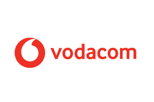 Vodacom company logo with red text and abstract red circular icon on a transparent background.