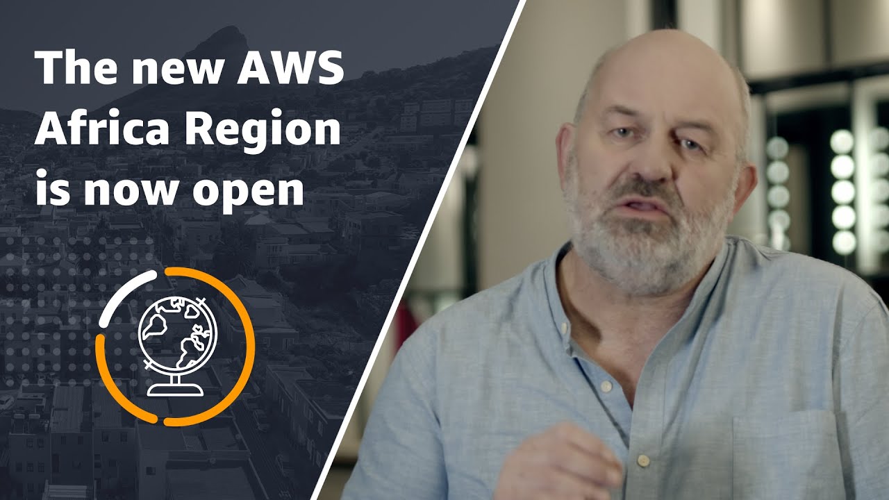 YouTube thumbnail showing a person speaking and the text 'The new AWS Africa Region is now open' alongside a globe icon, announcing the launch of the AWS Africa Region.