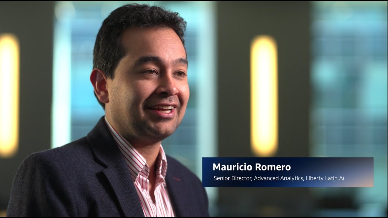 YouTube video thumbnail showing Mauricio Romero, Senior Director of Advanced Analytics at Liberty Latin Ar, in a professional office setting.