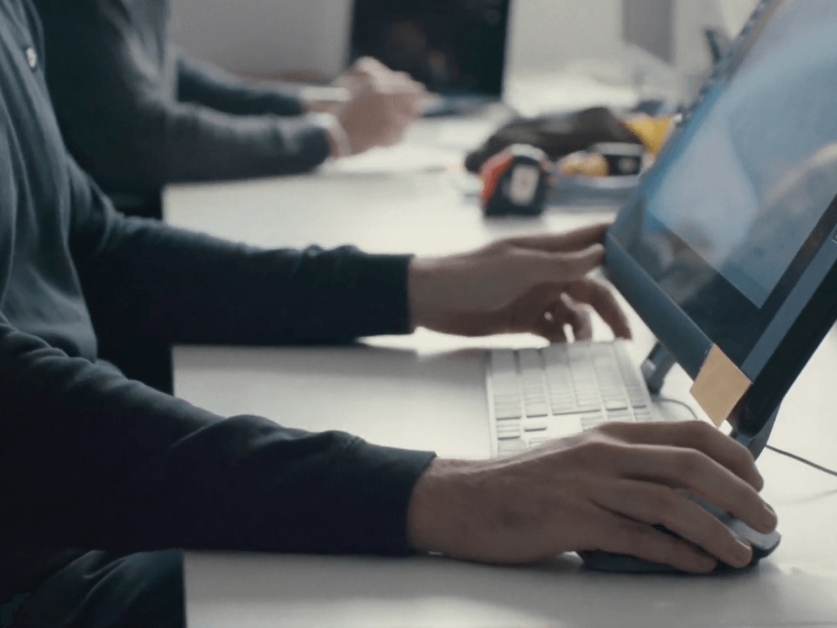 People working together at desktop computers.